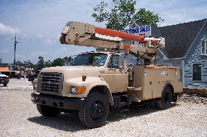 A bucket truck with material handler.