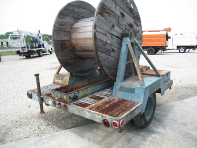 Blue single axle reel trialer.